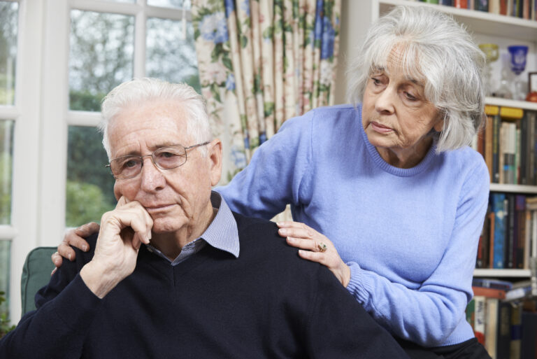 Woman comforting an aging man